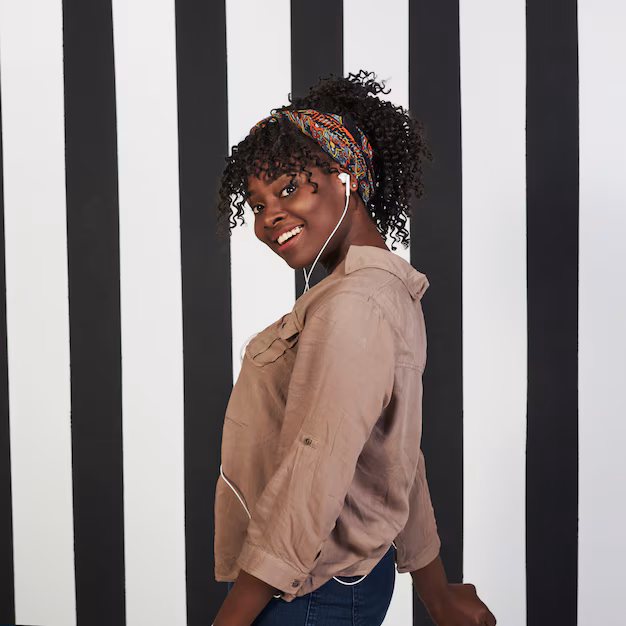 vertical-photo-smiled-afro-american-girl-stands-studio-with-vertical-white-black-lines-background_146671-14007.avif